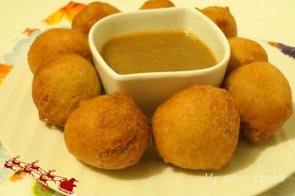 buns placed on a white bowl with a bowl containing caramel sauce for dipping