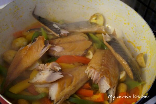 smoked mackerel added to a wok.