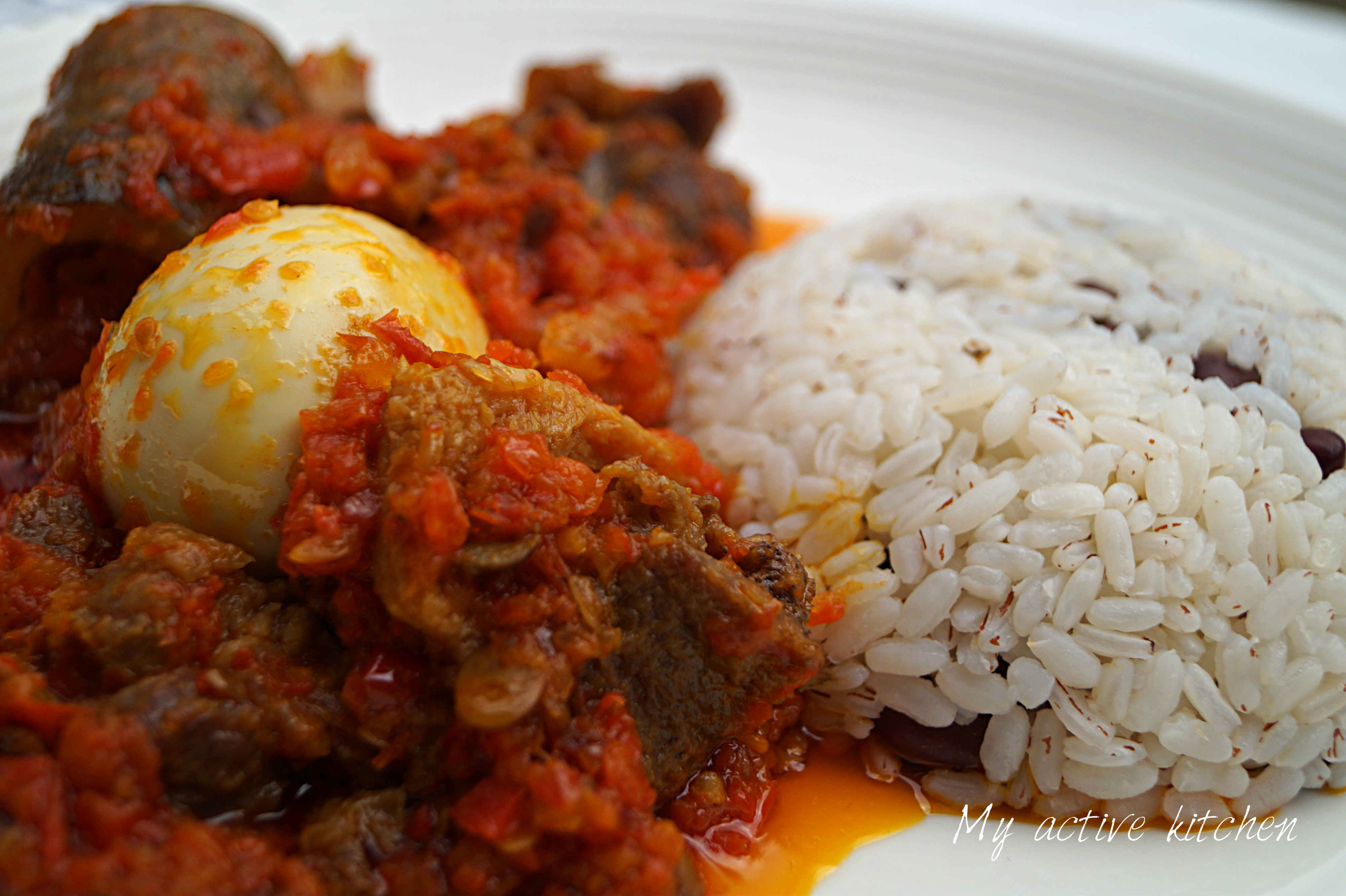 ofada rice and ofada stew on a plate