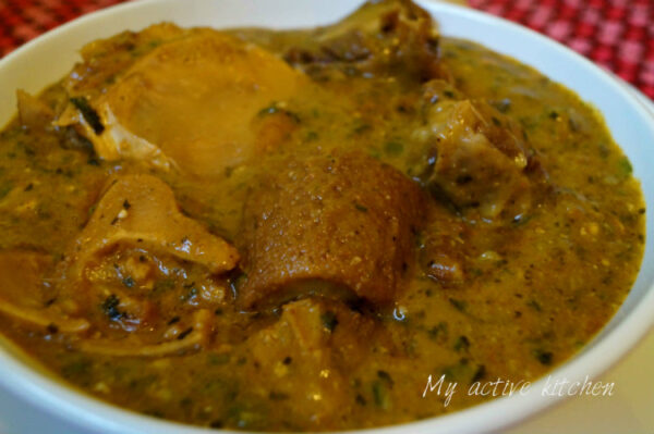 yoyo soup or ogbono soup with assorted meat in a white bowl..