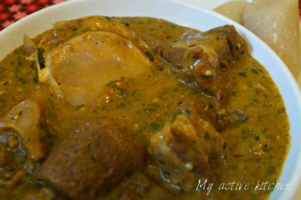 yoyo soup or ogbono soup with assorted meat in a white bowl..