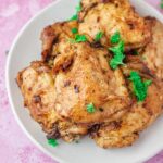 a plate of baked chicken thighs.