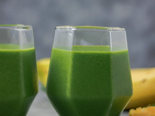 spinach smoothie in two glasses.