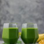 spinach smoothie in two glasses.