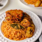 Nigerian smoky jollof rice served with peppered turkey and fried plantain.