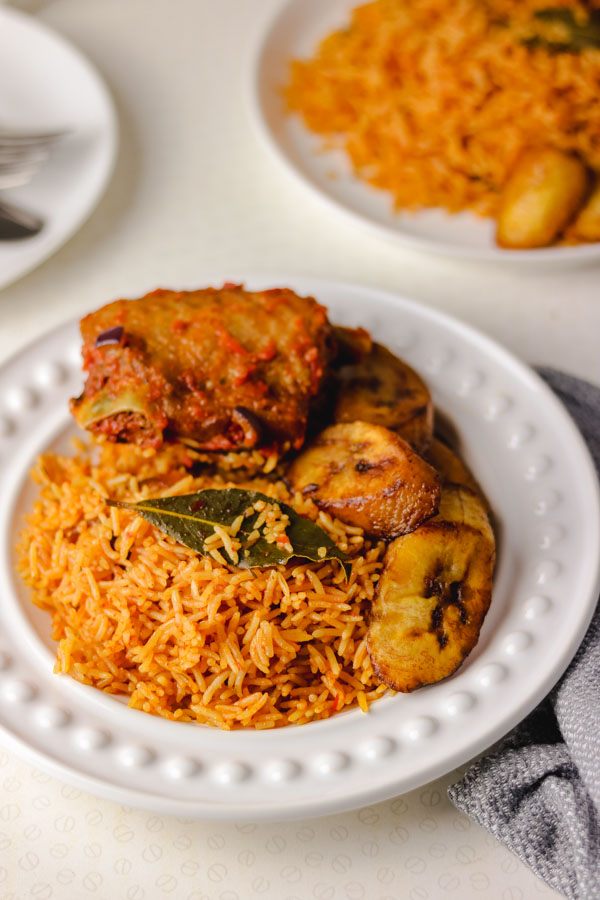 Nigerian smoky jollof rice served with peppered turkey and fried plantain.