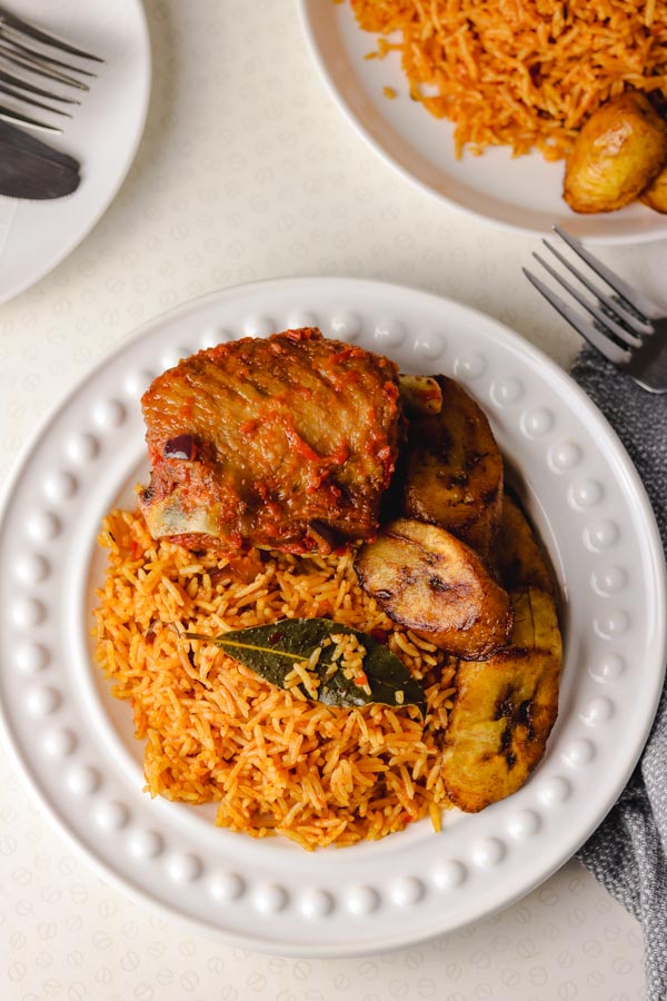 Nigerian smoky jollof rice served with peppered turkey and fried plantain.