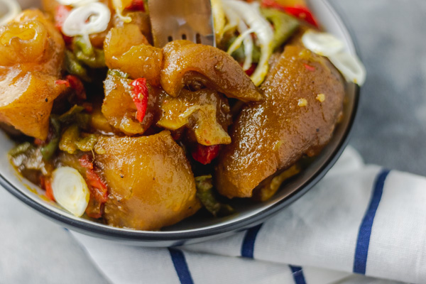  cow leg (cow foot/bokoto)in a black bowl placed on a napkin.