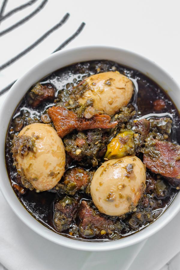 overhead shot of ayamase stew containing assorted meat and boiled eggs.