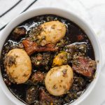 overhead shot of ayamase stew containing assorted meat and boiled eggs.