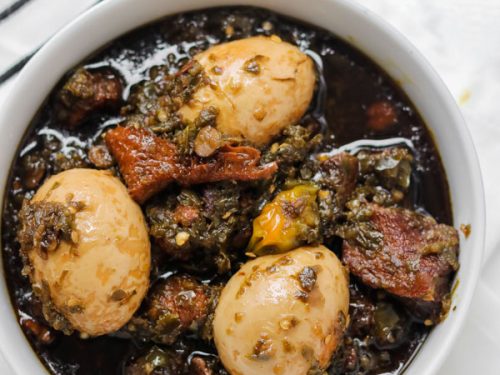 overhead shot of ayamase stew containing assorted meat and boiled eggs.