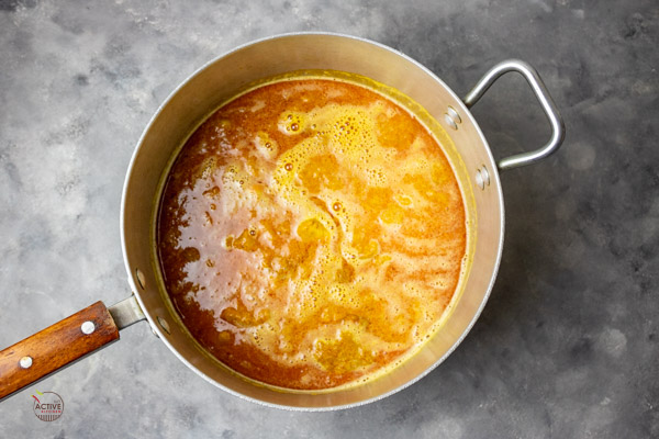 palm nut concentrate mixed with water in a pot.