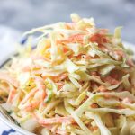 homemade coleslaw in a bowl placed on a napkin