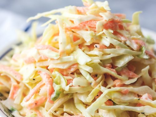 homemade coleslaw in a bowl placed on a napkin