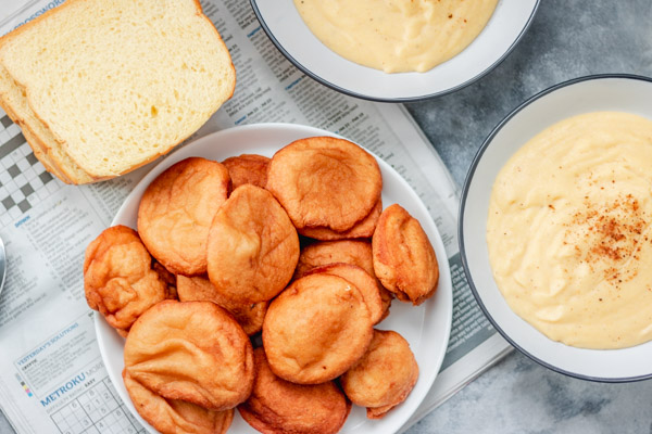 overhead shot of akara, brioche slices and cornmeal spread