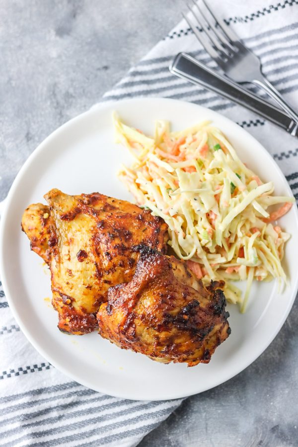 grilled chicken and salad in a bowl placed on a napkin