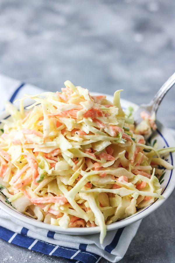 homemade coleslaw in a bowl placed on a napkin