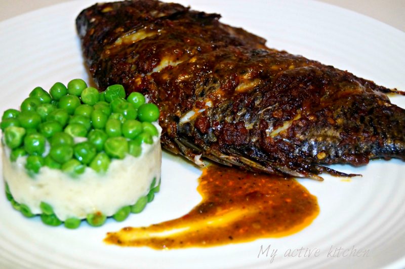 roasted harissa tilapia served with mashed yam and peas.