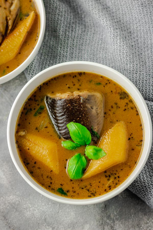 catfish pepper soup with plantain garnised with fresh basil.