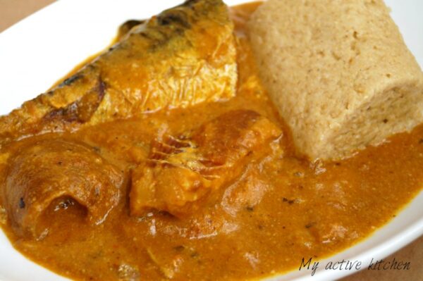 An angled photograph of ogbono soup loaded with mackerel, stock fish and ponmo