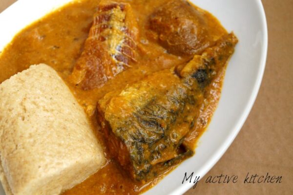 angled overhead shot of ogbono soup loaded with fried mackerel, panla and ponmo