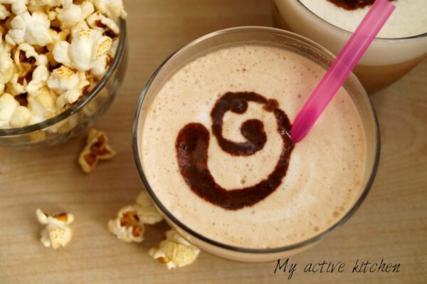 overhead shot of iced coffee with milky froth and chocolate swirl