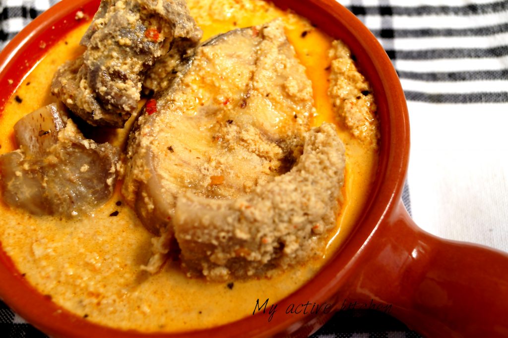 bowl of soup containing catfish and goat meat