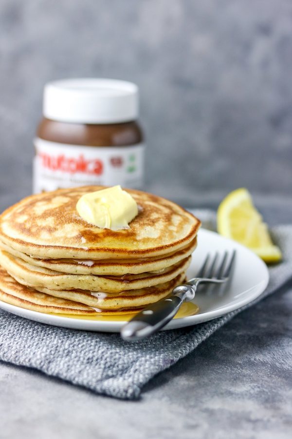 stack of nigerian pancake on a white plate. the pancake is placed on a grey napkin