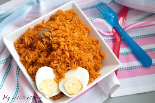 overhead shot of nigerian jollof rice and boiled egg cut in half