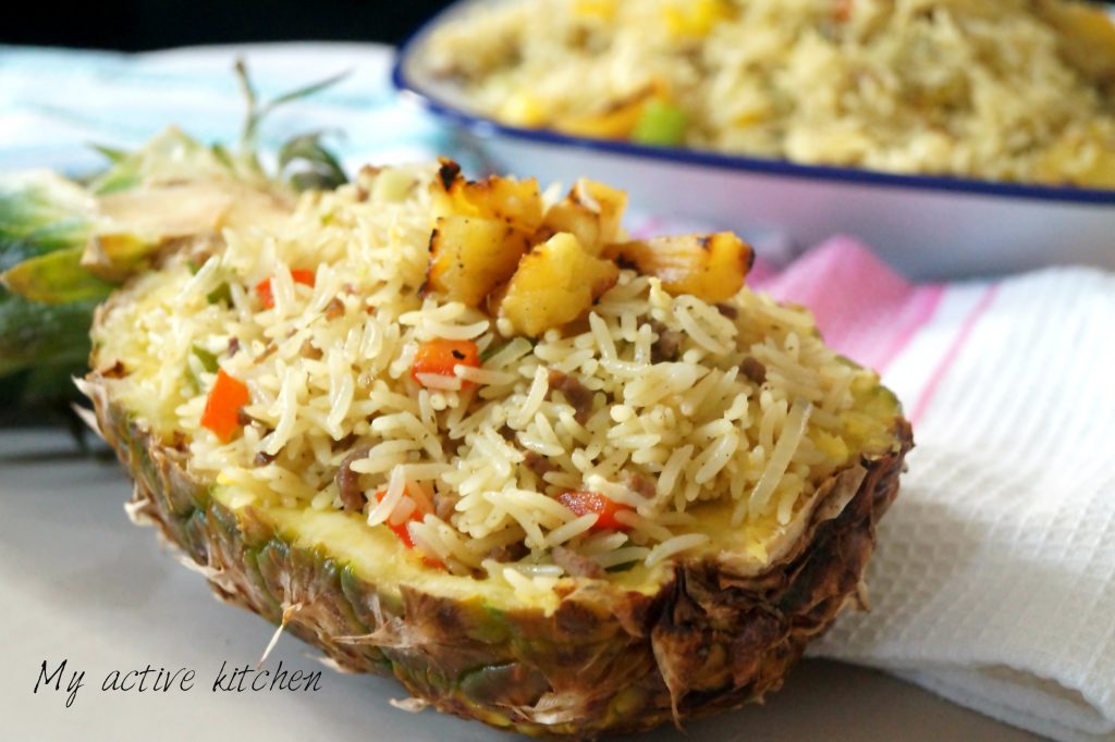 pineapple fried rice in a carved pineapple bowl