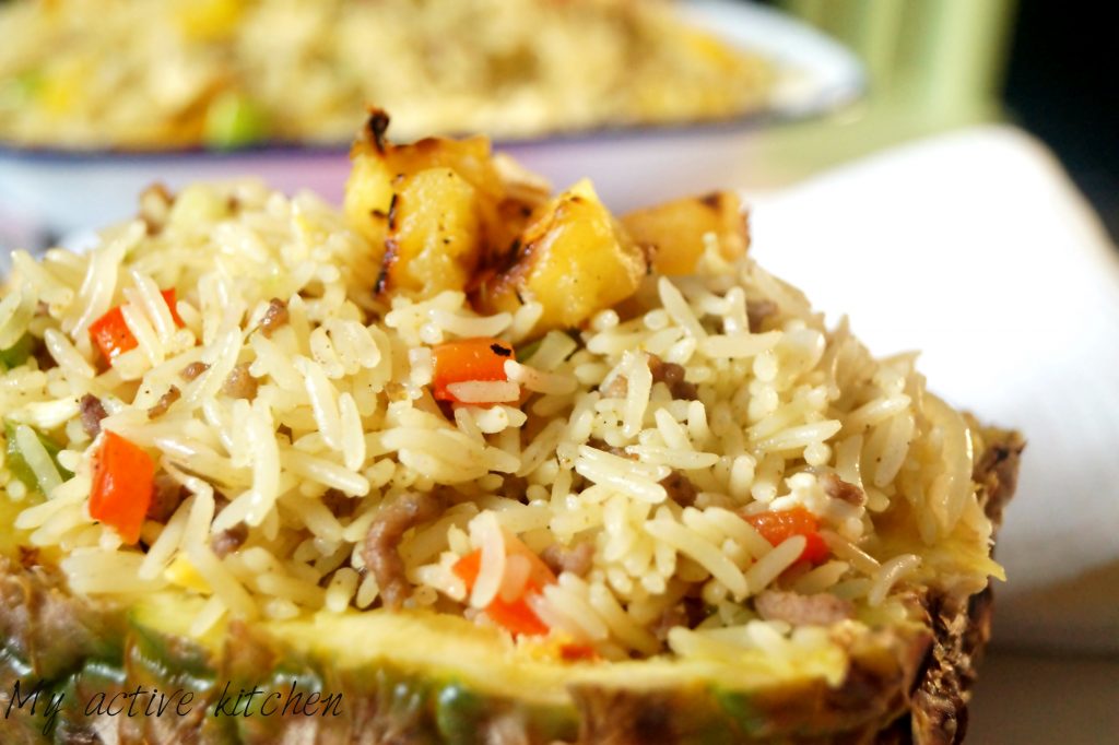 pineapple fried rice in a carved pineapple bowl