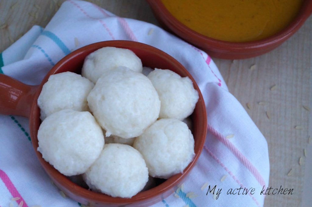 tuwo shinkafa in a brown ceramic bowl with a side of gbegiri also in the same coloured bowl