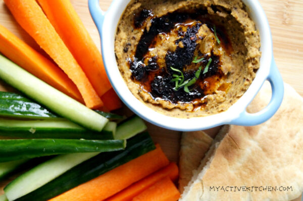 ewa aganyin dip served with cucumber, carrot baton and pita.