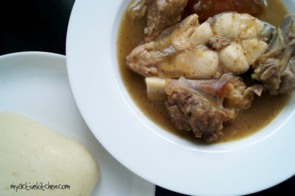 whire soup cooked with catfish and goat meat placed beside pounded yam