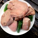 cleaned cow tongue steaks on a plate.