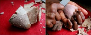 a hand srapping off the white bits on a cow tongue.