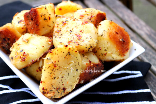 A front view of roasted potatoes in herbs and chillies