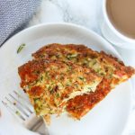 shot of zucchini frittata wedge on a white plate