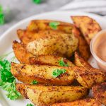 Well seasoned crispy potato wedges!! These crispy potatoes are sinfully good. Not only are they crispy on the outside, they are well seasoned and fluffy on the inside. The best part is they are baked and not fried!!! #easypotatorecipe #potatowedges #healthypotatowedges #healthyfrenchfries