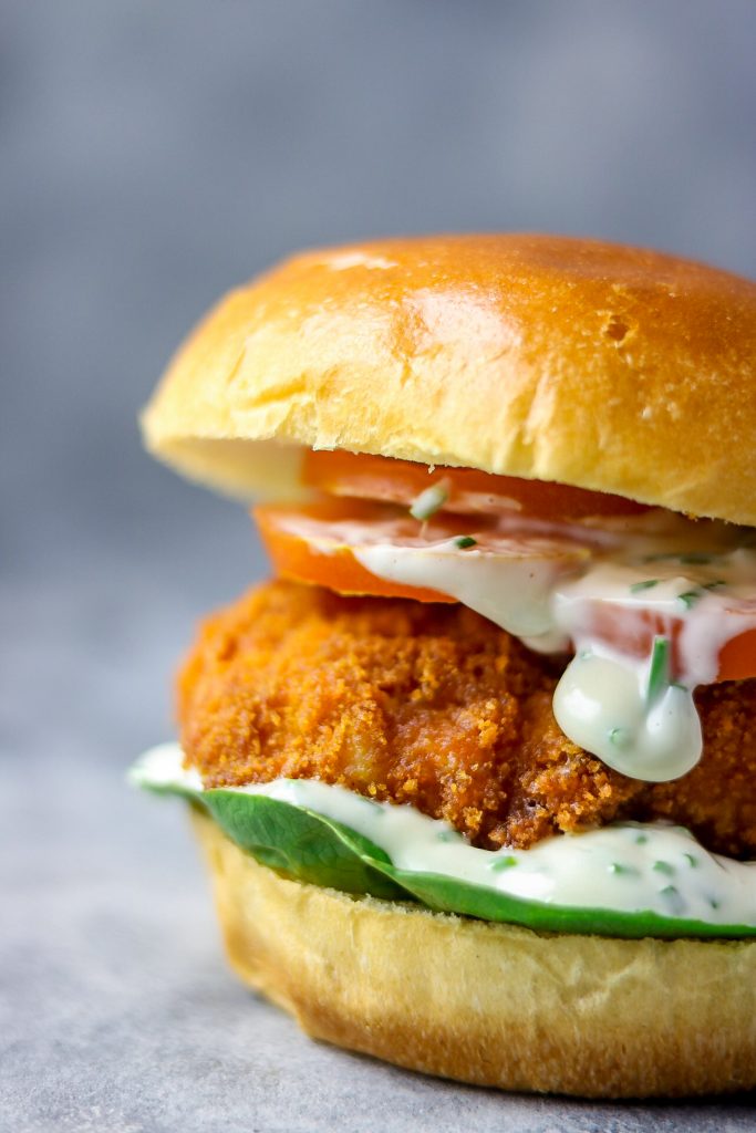 close shot fried fish burger and chive mayo dressing.