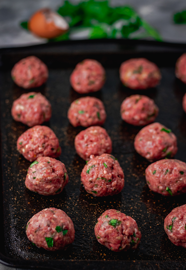  meatballs on a baking tray about to be baked