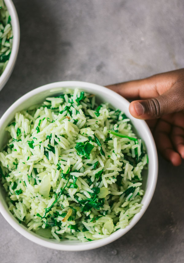 an image of spinach and rice in a white bowl