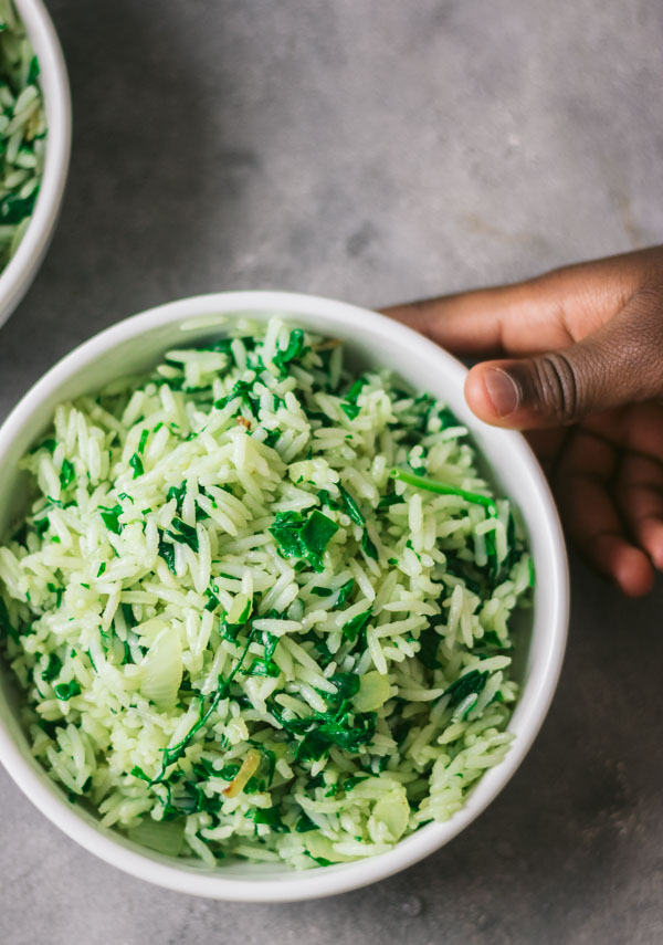 an image of spinach and rice in a white bowl