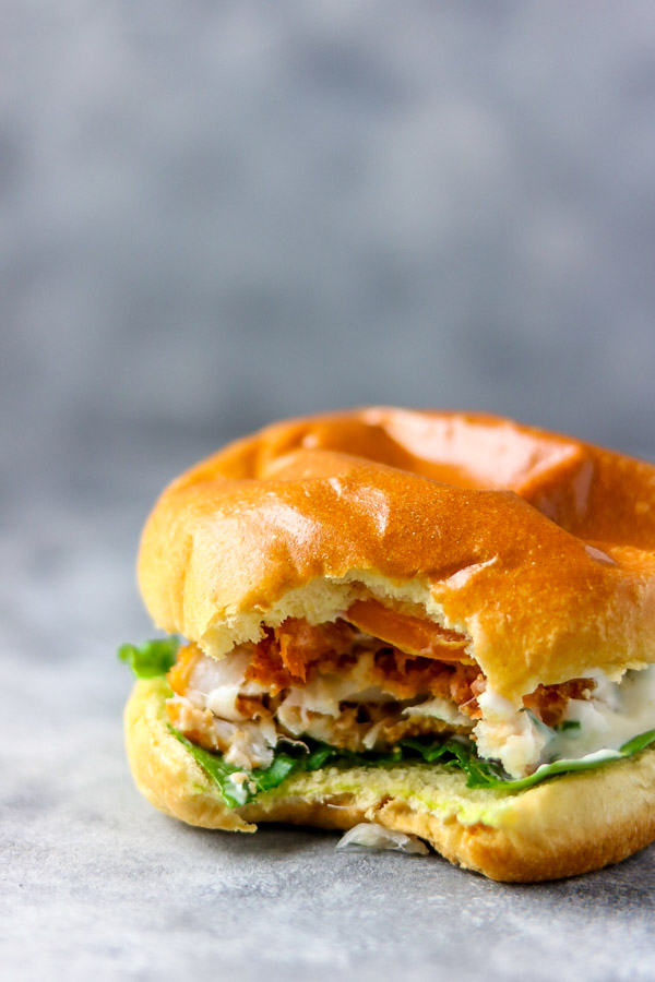 image of bite shot of crispy fish burger