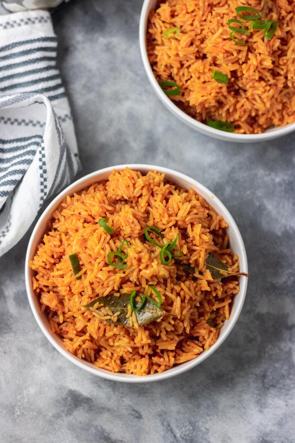 overhead shot of jollof rice with a garnish of bay leaf