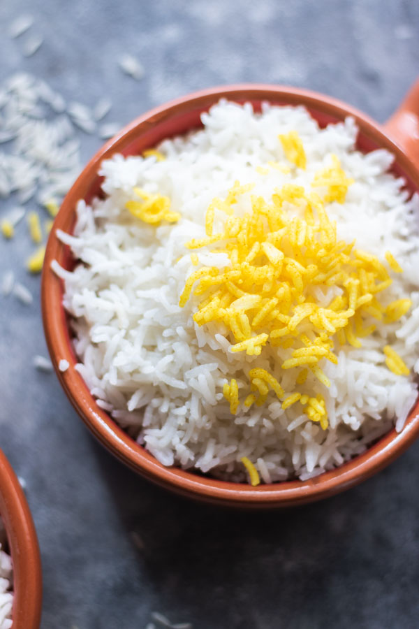 cooked basmati white rice and a garnish of turmeric rice 