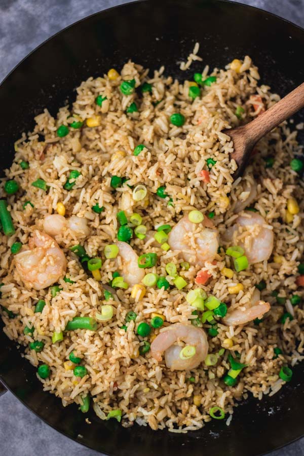 shrimp fried rice in a black wok.