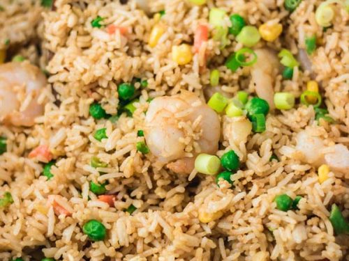 shrimp fried rice in a work with wooden ladle.