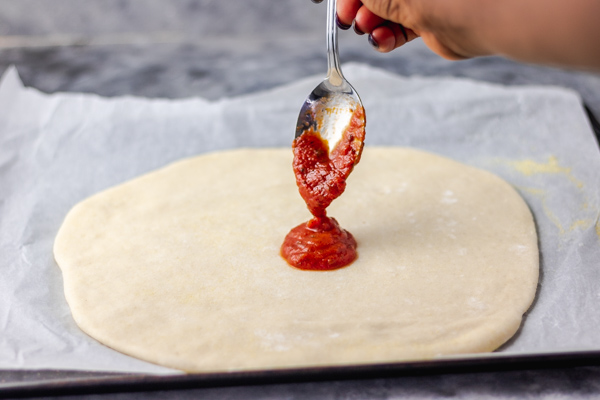 pizza dough and tomato sauce.