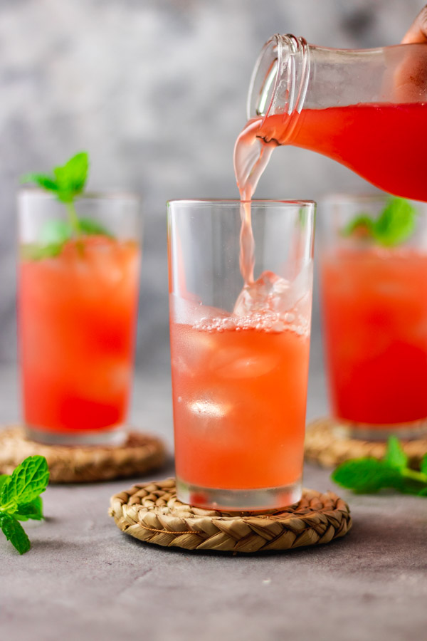 3 glasses filled with watermelon lemonade.